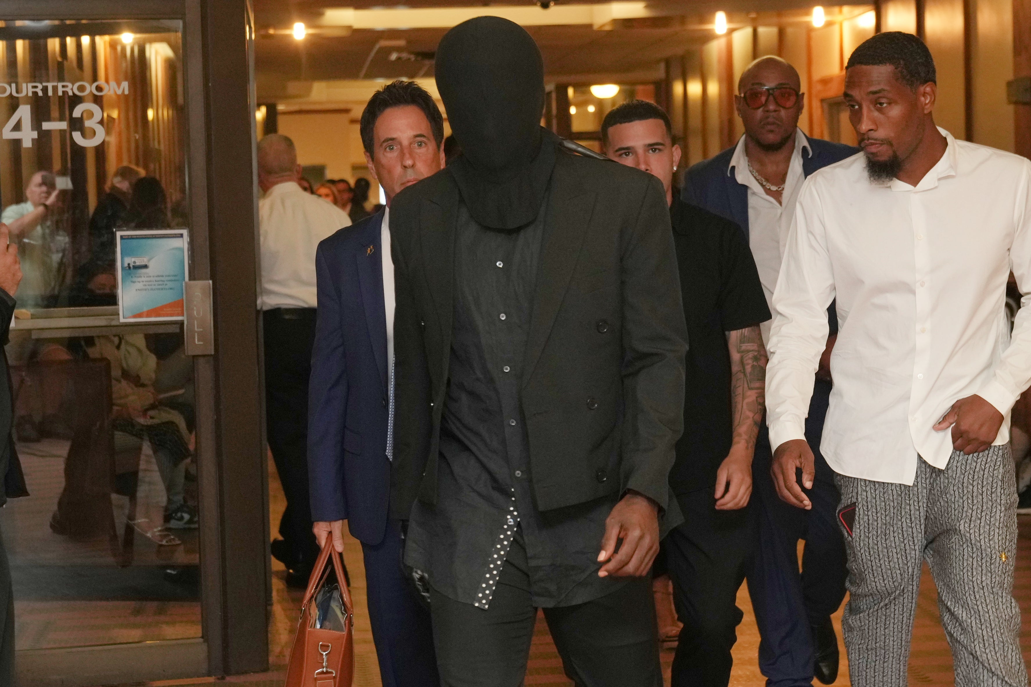 Brown wears a hood over his head as he leaves court