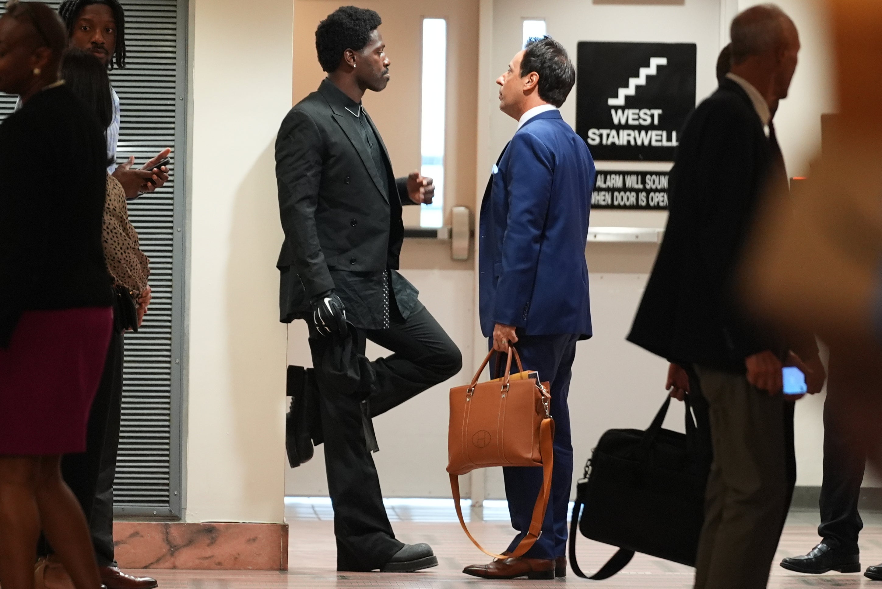 Antonio Brown speaks with his attorney Mark Eiglarsh before the court hearing Wednesday, Sept. 30, 2026, in Miami
