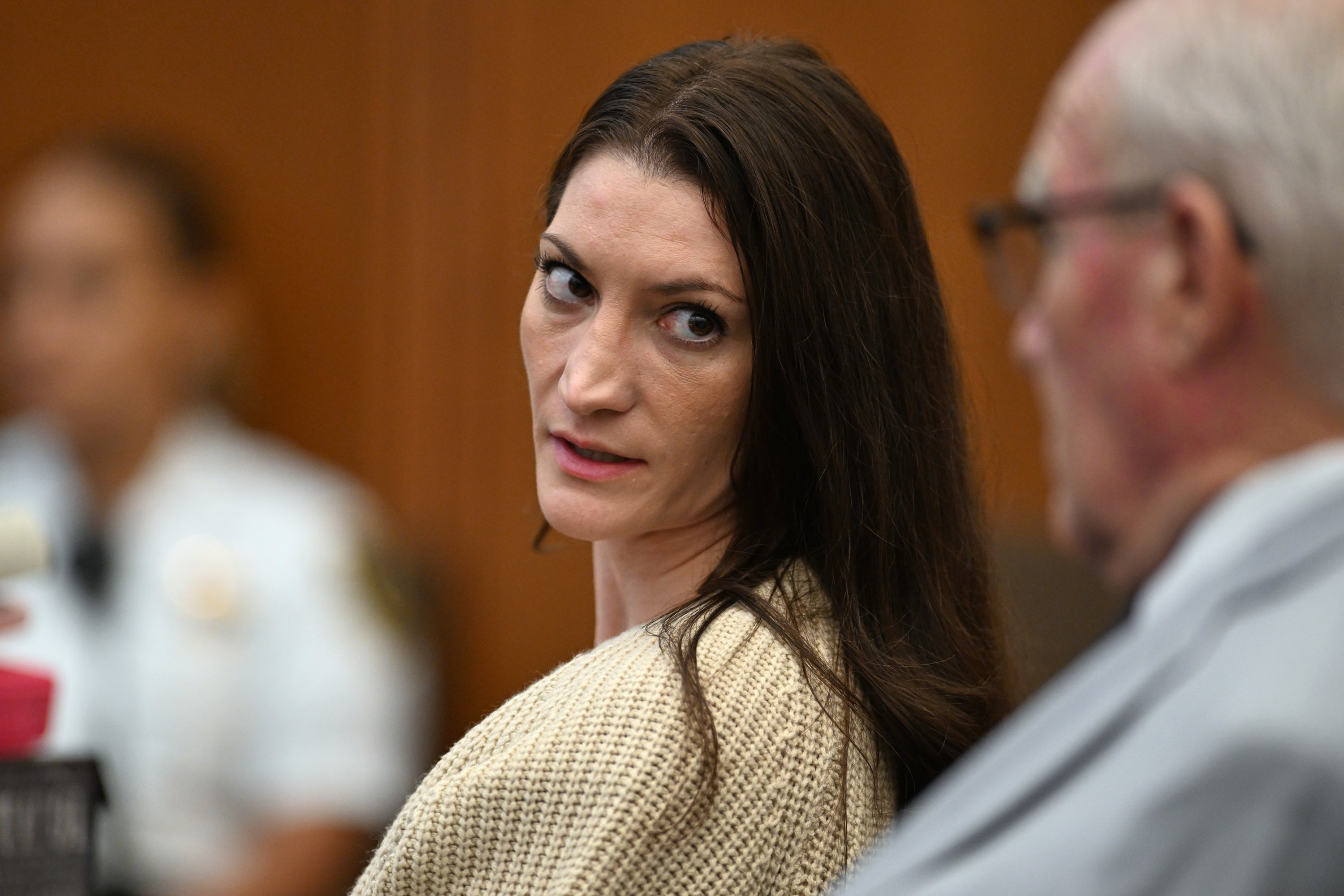 Lindsay Clancy, center, speaks with her lawyer Kevin Reddington during proceedings in her murder trial, Aug. 20, 2026, in Plymouth