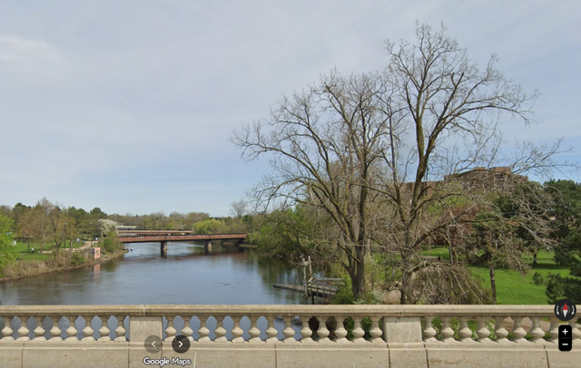 A view of the Grand River and a portion of the Lansing River Trail in Lansing, Michigan — city officials have deployed mobile surveillance trailers and extra night patrols along the greenway as unhoused residents report fearing an outside attacker