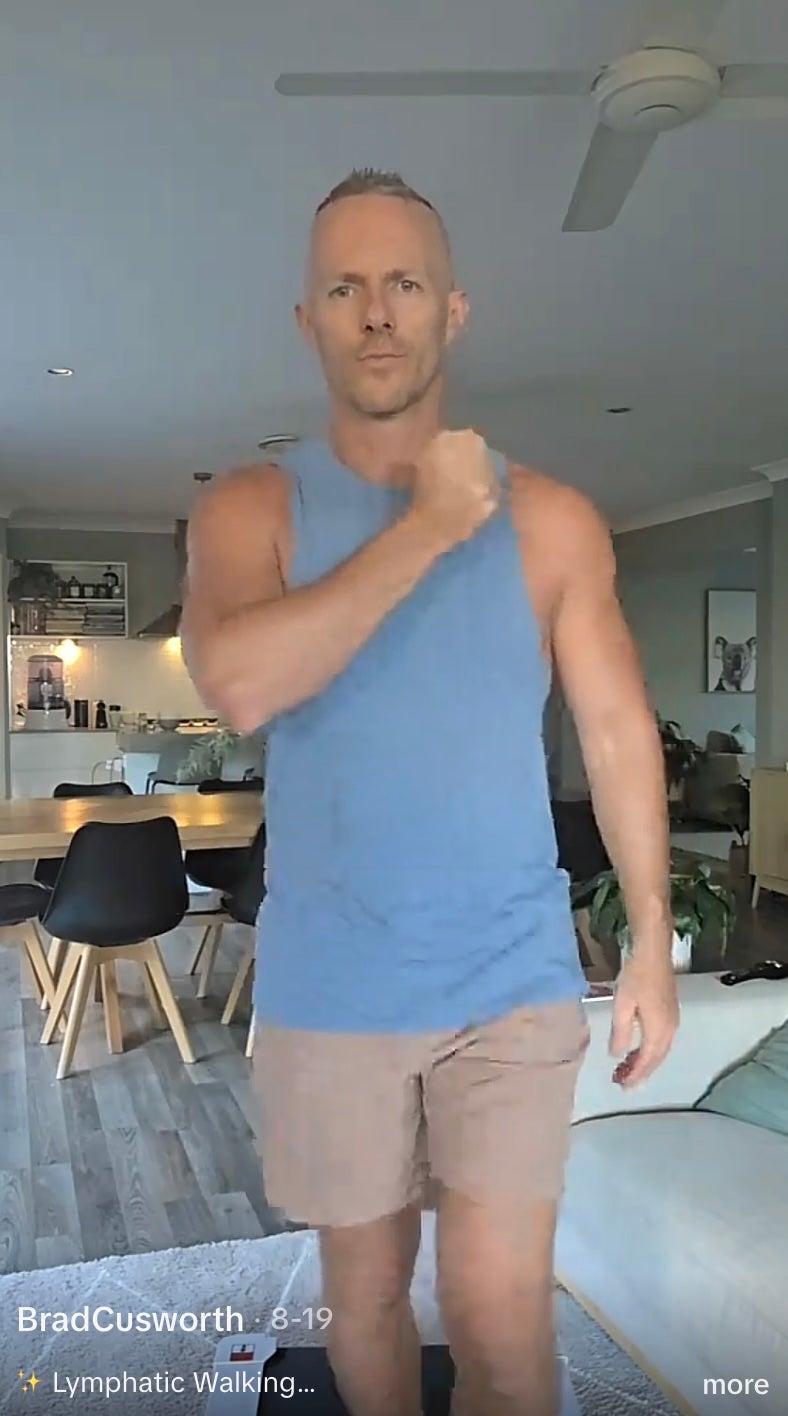 One TikTok user taps his chest while lymphatic walking on a walking pad. Swinging the arms is supposed to help fluid move through tissue that filters out harmful cells and other substances