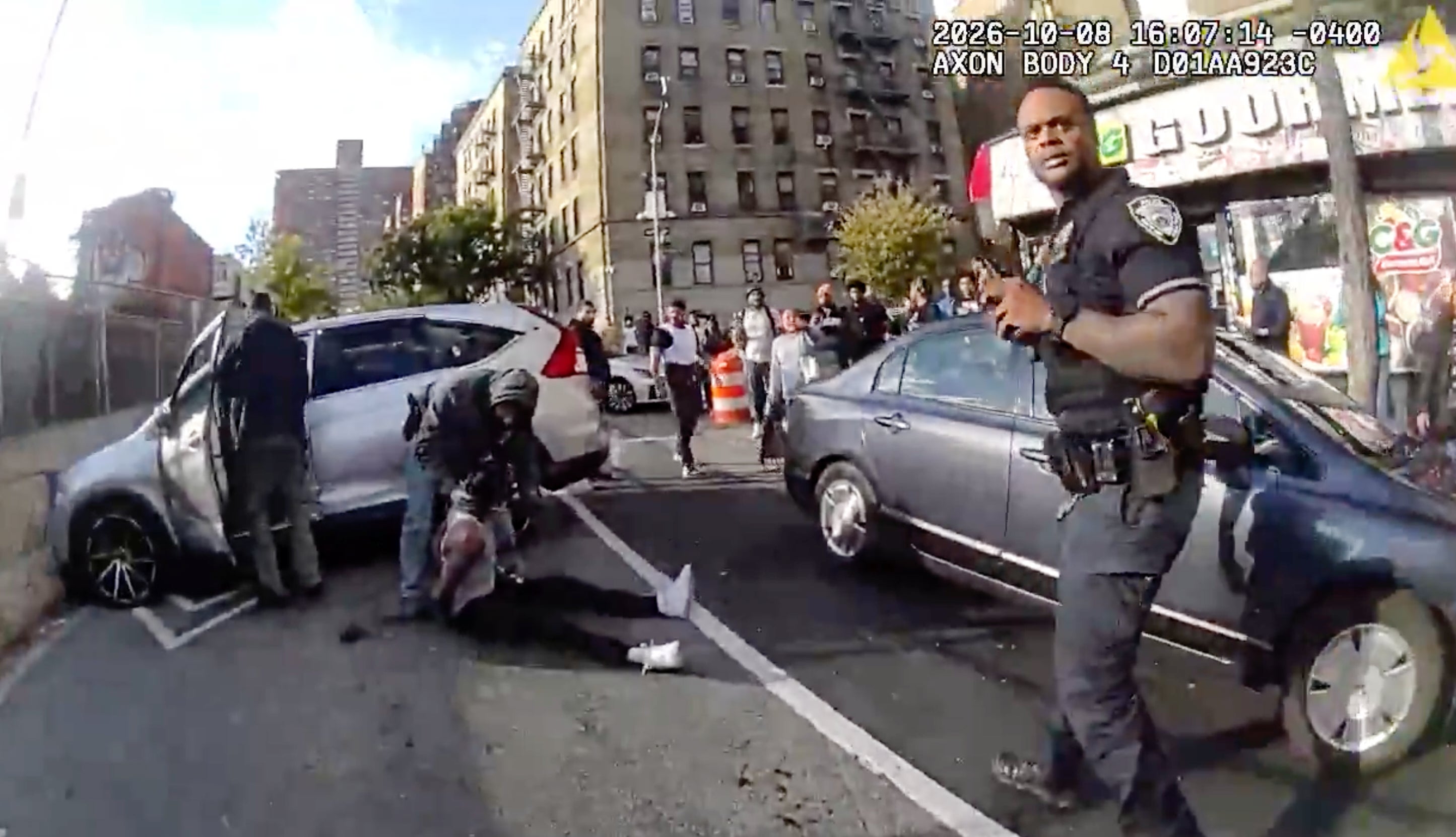 In this image taken from police-worn body camera video released the New York City Police Department (NYPD), law enforcement personnel tend to a Oscar Belgal, 28, a Dominican man who was shot by Federal immigration officers, Thursday, Oct. 8, 2026, in New York, as he drove his car with a 5-year-old boy inside.