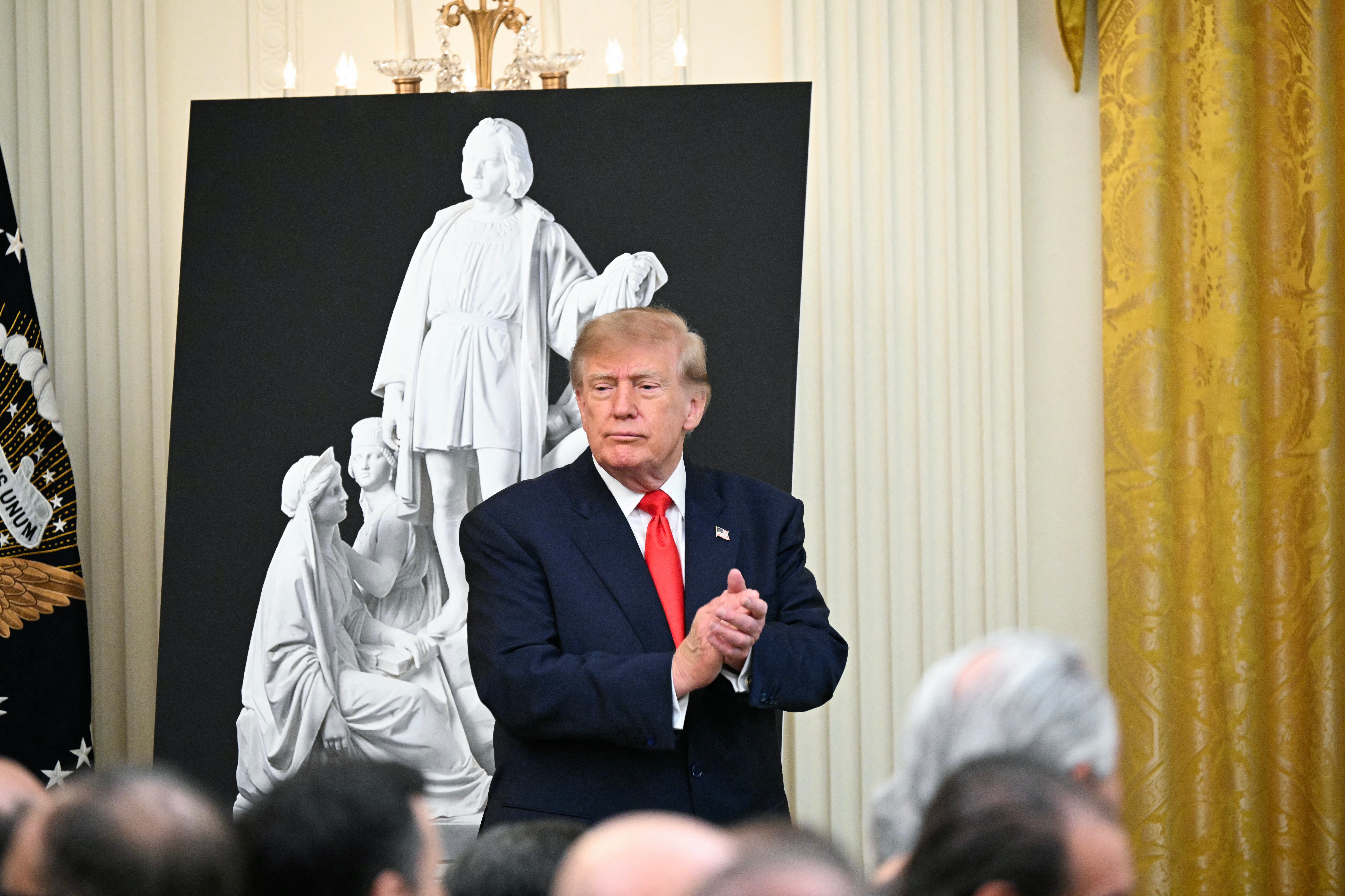 President Donald Trump reacts after speaking at a Columbus Day celebration in the East Room of the White House