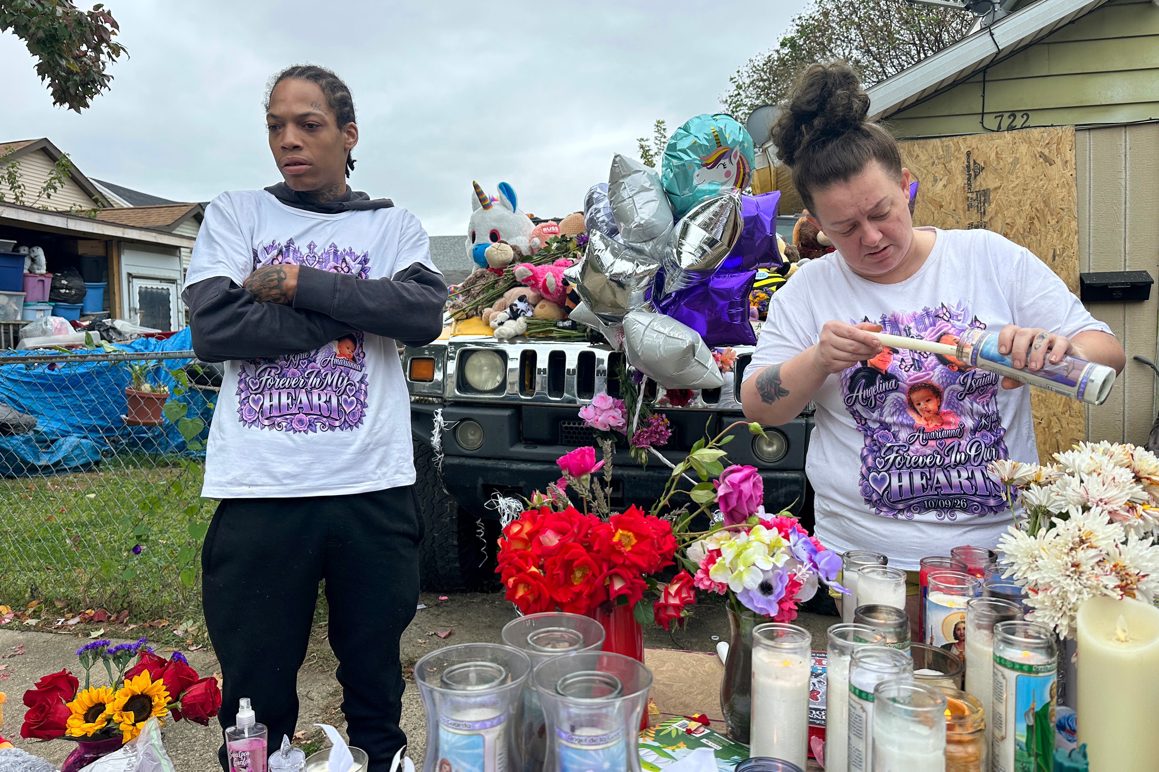 Julius Windham visits a memorial outside the home where authorities say a gunman killed eight people, including Windham's daughter, in Erie, Pennsylvania