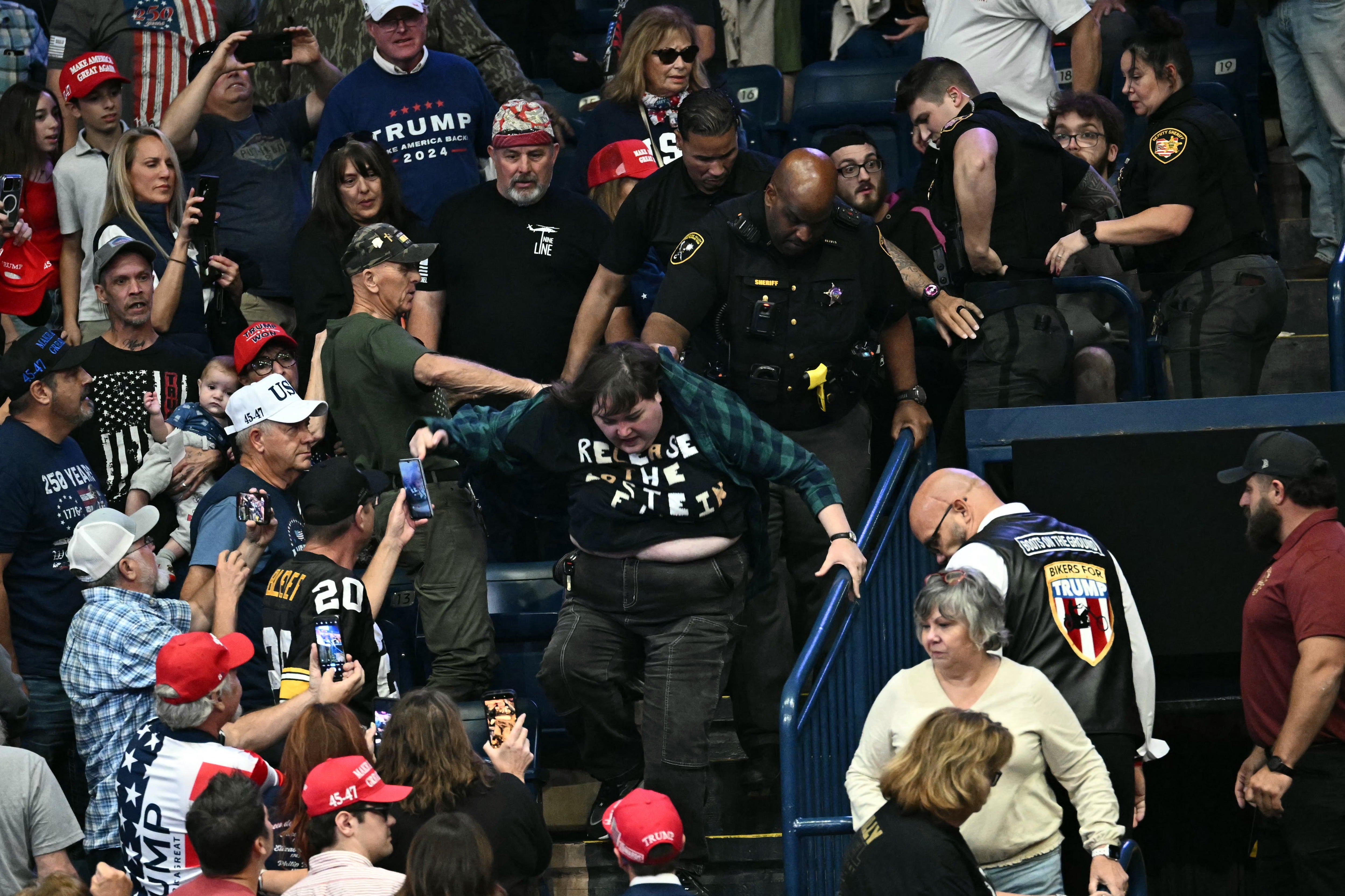 Trump rally attendees attack protester as he mocks her