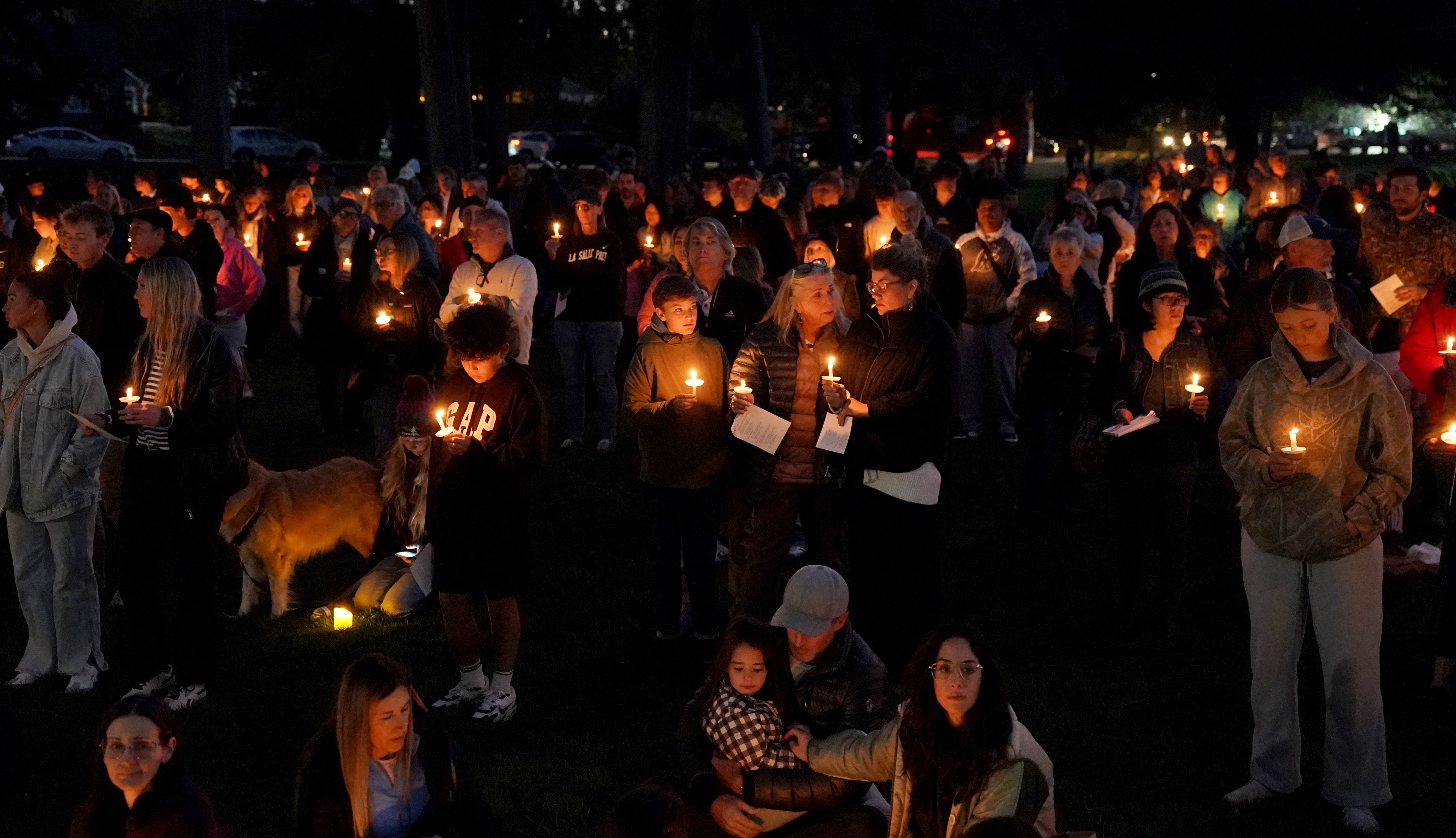 People gather for a candlelight vigil held in Drake Park in Bend, Oregon, following a shooting at Silver Rail Elementary School earlier in the day