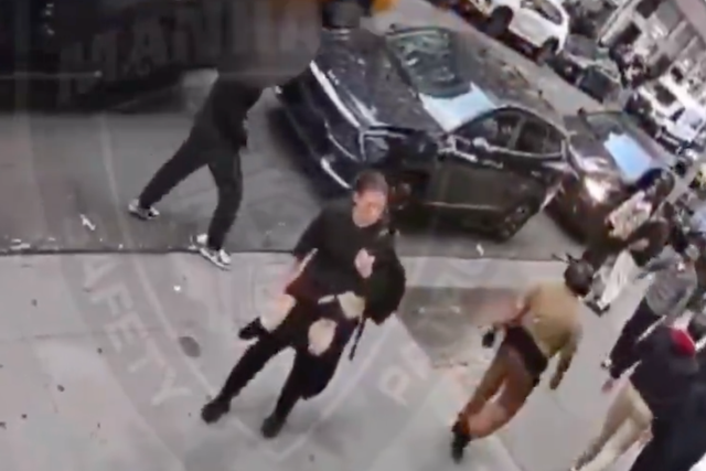 A woman is seen loitering in the street moments before the attack