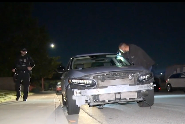 Detectives examine a damaged car thought to have been involved in the deadly collision in Montclair in which a group of Halloween cyclists were hit by a suspected DUI driver
