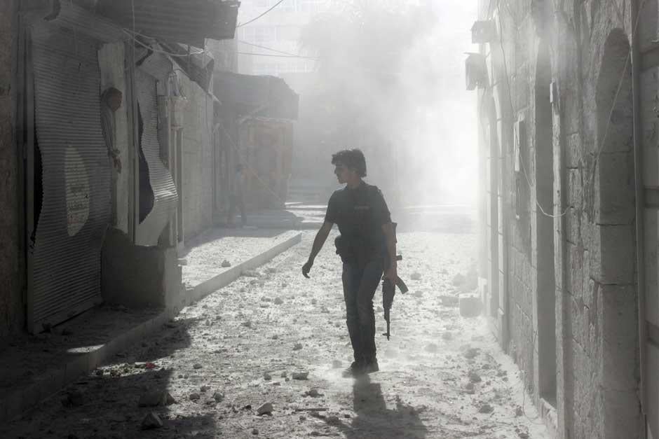 A rebel fighter on the streets of Aleppo in April