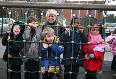 Retired teacher Sheila Abbott with children at Brookland School, London