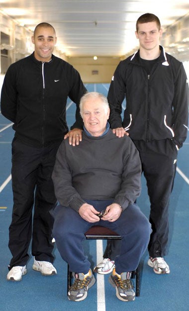 Sprinters Jason Gardner (left) and Craig Pickering (right), with coach Malcolm Arnold at Bath University's indoor 100m track