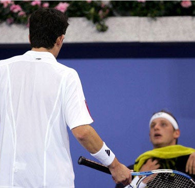 Henman and David Nalbandian argue after the Argentine's 6-2, 2-6, 7-5 victory in Madrid