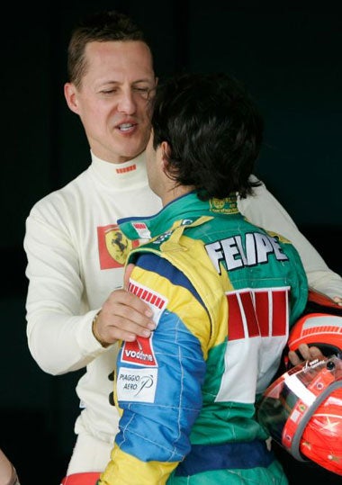 Schumacher congratulates local hero and team-mate Felipe Massa on his pole position