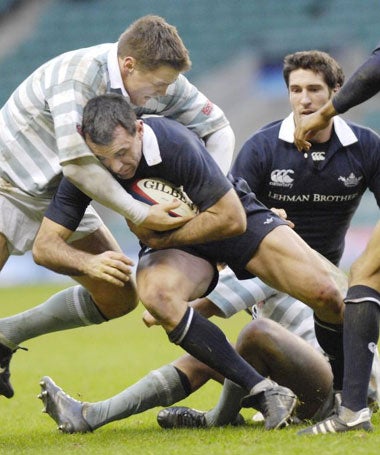 Cambridge's Daniel Stewart (left) tackles Joe Roff at Twickenham