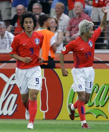 Korea's goal-scorers Ahn (left) and Lee Chun-Soo celebrate their country's winning goal