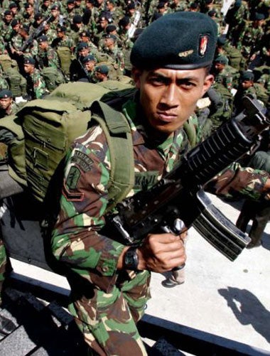 Indonesian soldiers board a navy ship in Aceh province