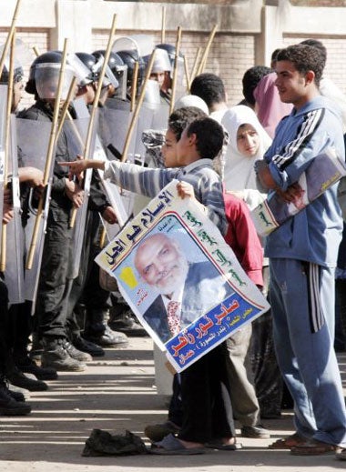 Supporters of the banned Muslim Brotherhood are prevented from entering a polling station