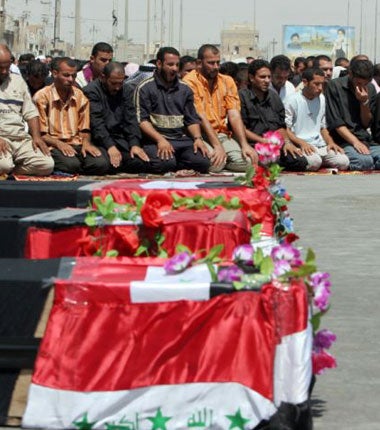 Worshippers at a ceremony for the hundreds of pilgrims killed in Baghdad