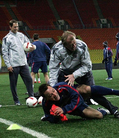 Captain, John Terry, tussles with Steve McClaren in training