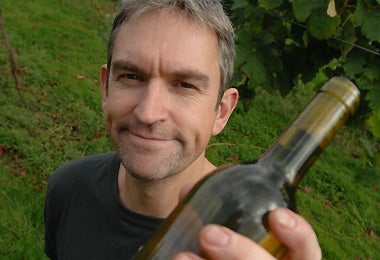 Chin-chin: Richard Sharp with a bottle of wine produced from grapes grown in a private garden in London
