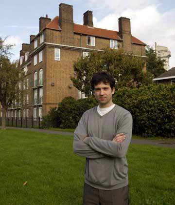 The artist outside his south London flat