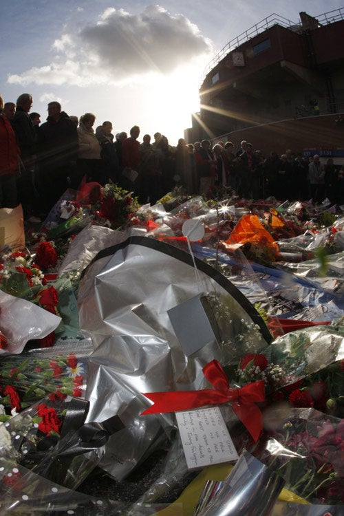 Fans pay tribute outside Old Trafford in Manchester