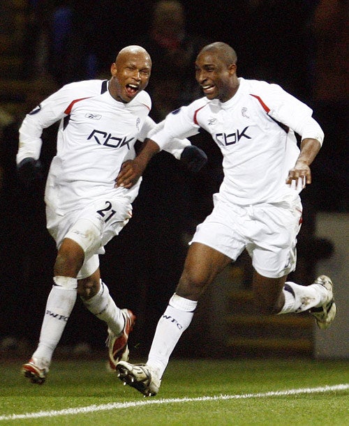 Bolton's goal scorer El Hadji Diouf (left) celebrates his goal against Atletico Madrid with teammate Jlloyd Samuel