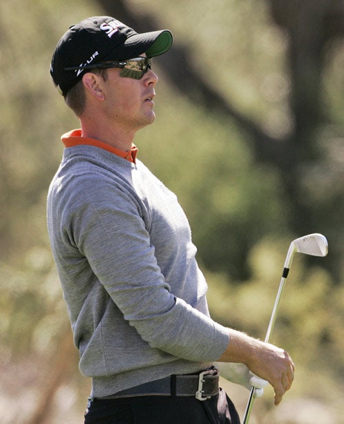 Stenson watches his tee shot on the 13th hole during the second round