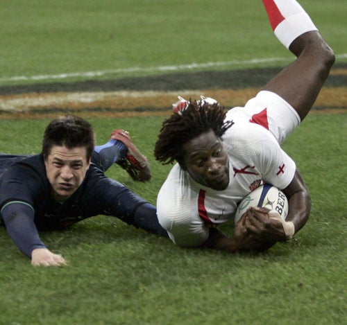 England winger Paul Sackey opens the scoring despite the desperate attempts of France's fly-half François Trinh-Duc