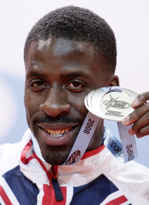 Chambers is all smiles after picking upthe silver medal for his 60m run yesterday