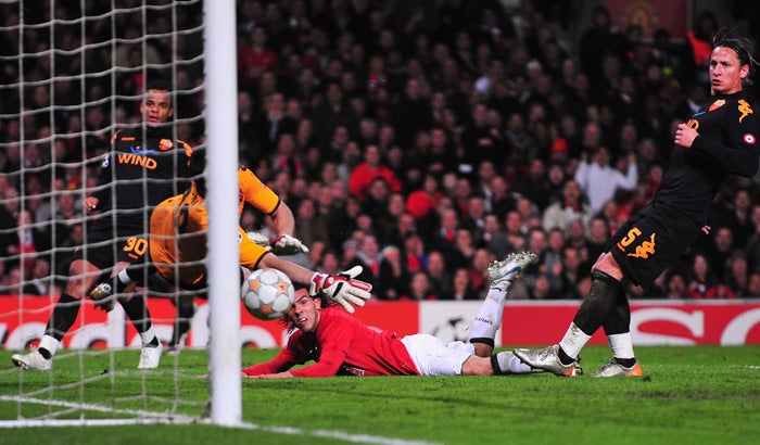 Carlos Tevez (centre) watches his diving, glancing header secure a 1-0 win at Old Trafford last night and a place in the last four