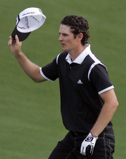 Rose acknowledges the crowd after completing his first round at Augusta