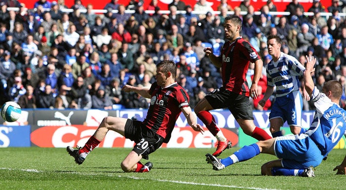 Brian McBride slides in to open the scoring for Fulham during their 2-0 victory over fellow strugglers Reading