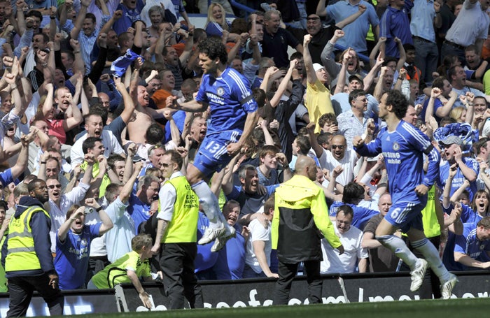 Chelsea's Michael Ballack celebrates after his second goal, a late penalty, earns the Blues a 2-1 victory over Manchester United to keep it tight at the top