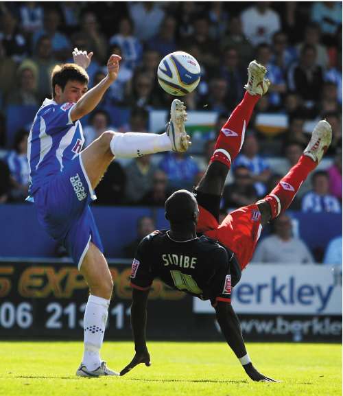 Stoke City's Mamady Sidibe (right) battles with Bela Balogh of Colchester