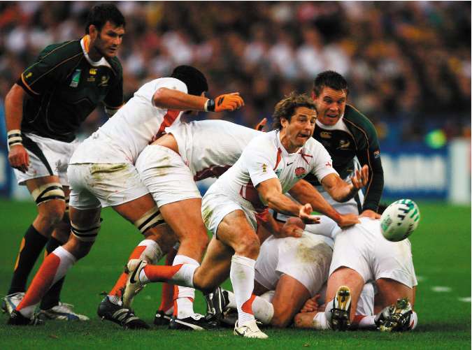 Andy Gomarsall passes the ball from the base of an England ruck. The radical proposal to legalise handling in the ruck has been dropped