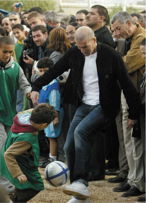 Former French international Zinedine Zidane shows his skills during a visit to a nursery for abandoned children in Algeria in 2006