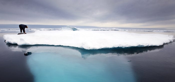 An Inuit seal hunter on a melting iceberg near Ammassalik Island, Greenland. Inuit groups have led calls for an international treaty to protect the Arctic