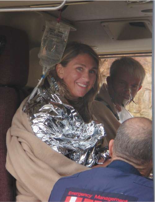 Scuba divers Alison Dalton and Richard Neely smile in a helicoptor after they were rescued