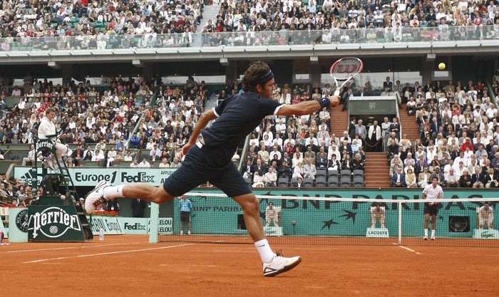 World No 1 Roger Federer hits a forehand on his way to victory in the French Open over Mario Ancic