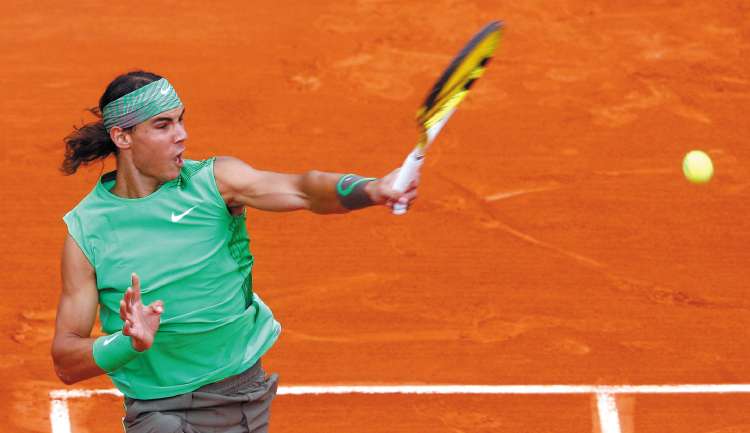 Rafael Nadal fires a return during his 6-1, 6-1, 6-1 victory over fellow Spaniard Nicolas Almagro in the quarter-finals of the French Open yesterday