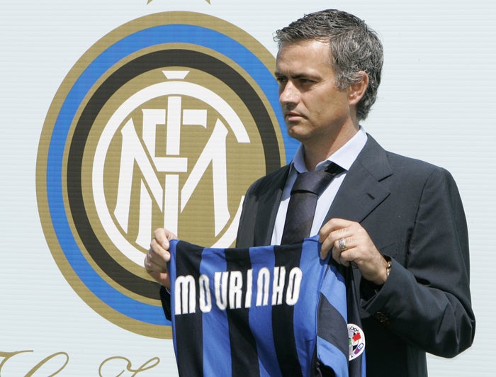 Mourinho admires an Internazionale shirt after being unveiled as the Italian champions' coach yesterday