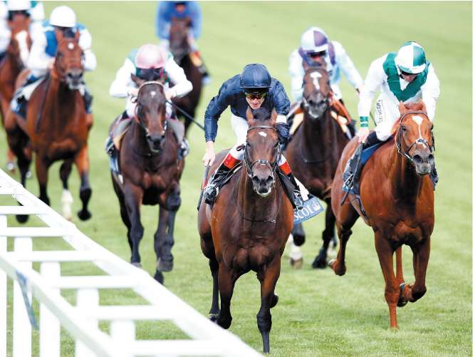 Henrythenavigator (blue silks) lands the St James's Palace Stakes with Raven's Pass (right) in pursuit