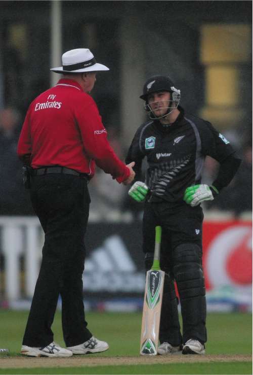 New Zealand's Brendon McCullum shows his disgust as the umpire, Steve Davis, brings play to a halt