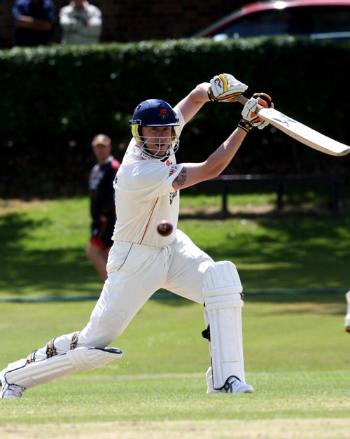 Andrew Flintoff drives yesterday on the way to scoring 56 off 73 balls before being caught on his first outing since suffering a side strain in early May