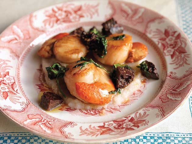 Place the scallops on top of the Jerusalem artichoke purée then spoon the butter and black pudding over