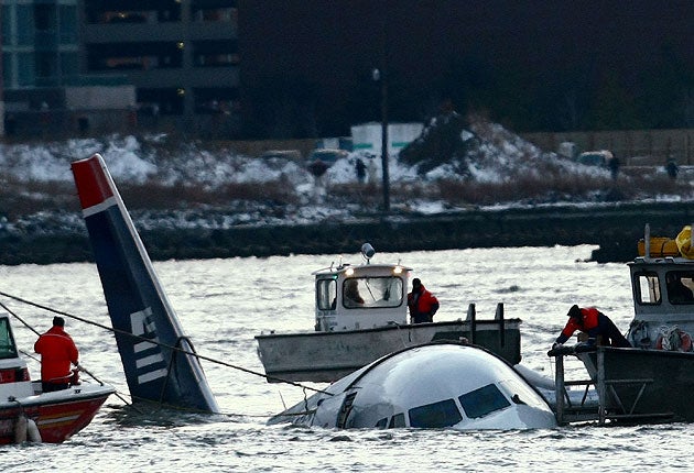 Rescue crews secure a US Airways flight 1549 floating in the water after it crashed into the Hudson River on 15 January, 2009, in New York City