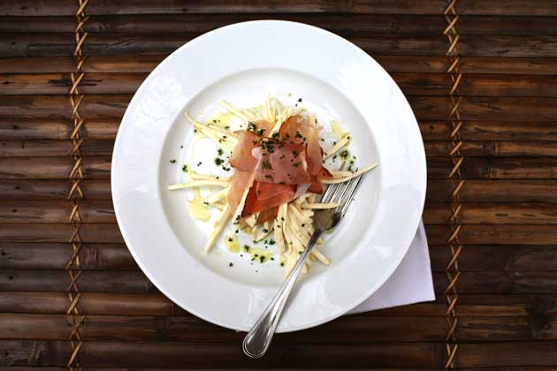 To serve, divide the remoulade between four plates, place three slices of speck on top and sprinkle over the parsley