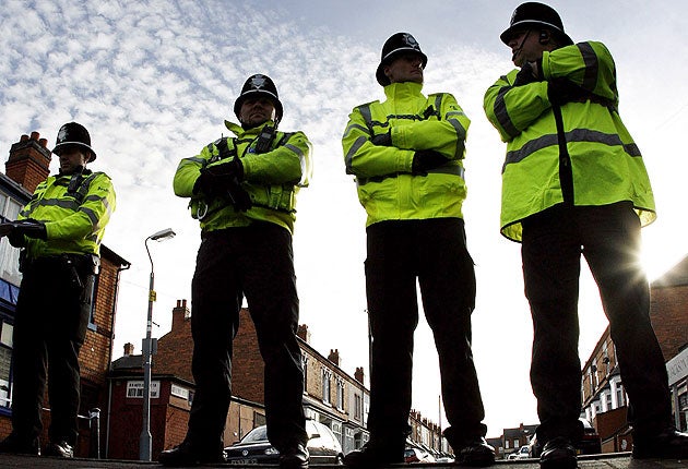 Police officers guard a Birmingham road after anti-terror arrests in 2007