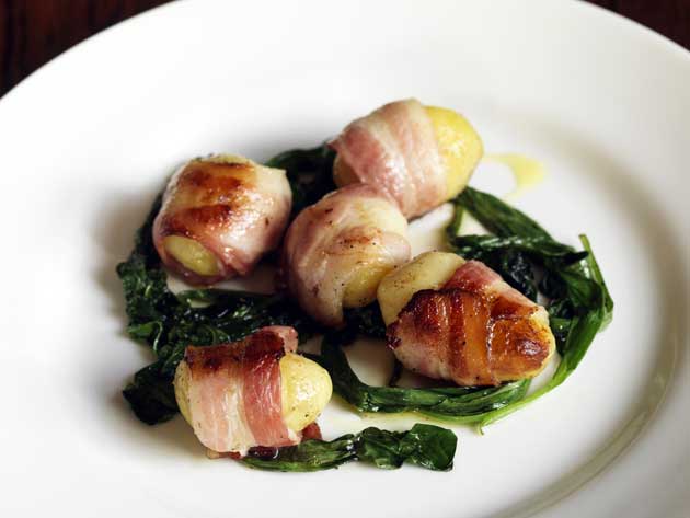 To serve, spoon the wild garlic leaves on to warmed plates and place the potatoes on top